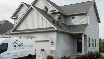 Roof inspection team assessing vinyl siding and shingles in Jacksonville FL home exterior